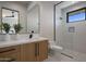 Bathroom with a floating vanity and a glass shower at 29646 N 109Th Pl # 128, Scottsdale, AZ 85262