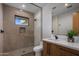 Modern bathroom with a walk-in shower and wood vanity at 29646 N 109Th Pl # 128, Scottsdale, AZ 85262