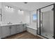 Elegant bathroom featuring dual sinks, a soaking tub, and a walk-in shower at 22782 E Stacey Rd, Queen Creek, AZ 85142