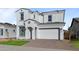 Two-story house with white exterior, gray tile roof, and a two-car garage at 22782 E Stacey Rd, Queen Creek, AZ 85142