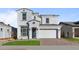 Two-story home with white exterior, gray tile roof, and landscaped front yard at 22782 E Stacey Rd, Queen Creek, AZ 85142