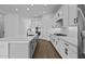 Modern kitchen with white cabinets, quartz countertops, and wood-look tile floors at 22782 E Stacey Rd, Queen Creek, AZ 85142
