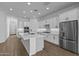 Modern kitchen with white cabinets, large island, and stainless steel appliances at 22782 E Stacey Rd, Queen Creek, AZ 85142