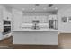 Modern kitchen with white cabinets, large island, and stainless steel appliances at 22782 E Stacey Rd, Queen Creek, AZ 85142
