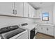 Laundry room with white cabinets, washer, and dryer at 22782 E Stacey Rd, Queen Creek, AZ 85142