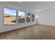 Living room with large windows, hardwood floors, and views of the backyard at 22782 E Stacey Rd, Queen Creek, AZ 85142