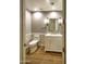 Modern bathroom with white vanity, gray walls, and wood-look flooring at 7175 E Camelback Rd # 704, Scottsdale, AZ 85251