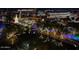 Night time aerial view of a city with water features and lights at 7175 E Camelback Rd # 704, Scottsdale, AZ 85251