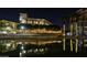 Night view of illuminated canal, with buildings and palm trees reflecting in the water at 7175 E Camelback Rd # 704, Scottsdale, AZ 85251