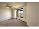 Bright bedroom with large window offering city views and gray carpeting at 7175 E Camelback Rd # 704, Scottsdale, AZ 85251