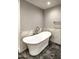 Bathroom with freestanding tub and marble tile at 7175 E Camelback Rd # 704, Scottsdale, AZ 85251