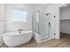 Modern bathroom with a free-standing bathtub and walk-in shower at 37520 W Padilla St, Maricopa, AZ 85138