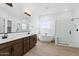 Elegant bathroom with double vanity, soaking tub, and shower at 37520 W Padilla St, Maricopa, AZ 85138