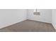 Simple bedroom with neutral carpeting and a window at 37520 W Padilla St, Maricopa, AZ 85138