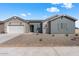 One-story home with gray siding, white garage door, and landscaped front yard at 37520 W Padilla St, Maricopa, AZ 85138