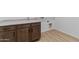 Laundry room with wooden cabinets and vinyl flooring at 37520 W Padilla St, Maricopa, AZ 85138