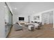 Spacious living room with hardwood floors, neutral furniture and sliding doors to patio at 37520 W Padilla St, Maricopa, AZ 85138