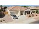 Single-story home with a two-car garage and landscaped yard at 17750 W Pershing St, Surprise, AZ 85388