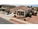 Single-story home with a terracotta roof and landscaped front yard, featuring a driveway and a car parked at 17750 W Pershing St, Surprise, AZ 85388