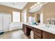 Double vanity bathroom with a soaking tub and separate shower at 17750 W Pershing St, Surprise, AZ 85388