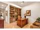 Home office with built-in shelves and hardwood floors at 28080 N 101St St # 116, Scottsdale, AZ 85262