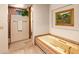 Relaxing bathroom with soaking tub, tile shower and decorative artwork at 28080 N 101St St # 116, Scottsdale, AZ 85262