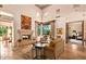 Open living room with stone fireplace and views to backyard at 28080 N 101St St # 116, Scottsdale, AZ 85262