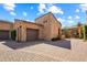 Stone and stucco exterior of the home's garage at 28080 N 101St St # 116, Scottsdale, AZ 85262