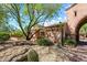 Spanish-style home with stone exterior, landscaped courtyard, and arched entryway at 28080 N 101St St # 116, Scottsdale, AZ 85262