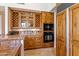 Kitchen features wood cabinetry, tile backsplash and appliances at 28080 N 101St St # 116, Scottsdale, AZ 85262