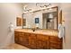 Bathroom with double vanity, granite countertop and decorative tilework at 28080 N 101St St # 116, Scottsdale, AZ 85262