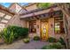 Elegant entryway with stonework and a wooden door at 28080 N 101St St # 116, Scottsdale, AZ 85262