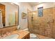 Bathroom with tiled shower, vanity, and modern toilet at 28080 N 101St St # 116, Scottsdale, AZ 85262