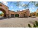 View of the home's garage and the stone driveway at 28080 N 101St St # 116, Scottsdale, AZ 85262