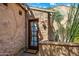 Exterior view of a stone building with a red door and landscaping at 28080 N 101St St # 116, Scottsdale, AZ 85262