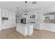 Modern kitchen with white cabinets, stainless steel appliances, and a large island at 37645 W Padilla St, Maricopa, AZ 85138