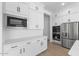 White kitchen cabinets, stainless steel appliances, and quartz countertops at 37645 W Padilla St, Maricopa, AZ 85138