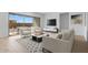Living room with comfy seating, large TV, and access to the backyard at 37645 W Padilla St, Maricopa, AZ 85138