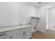Bright laundry room with built in cabinets and sink at 37645 W Padilla St, Maricopa, AZ 85138