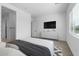 Bright bedroom with a large bed and built-in TV stand at 37645 W Padilla St, Maricopa, AZ 85138