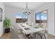 Elegant dining room with marble table, six chairs, and access to the patio at 37645 W Padilla St, Maricopa, AZ 85138