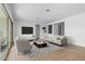 Bright living room features wood-look floors and stylish furniture at 37645 W Padilla St, Maricopa, AZ 85138