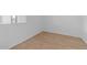 Empty bedroom with light walls and wood-look floors at 37645 W Padilla St, Maricopa, AZ 85138