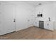 Modern wet bar with white cabinets and a mini-fridge at 37645 W Padilla St, Maricopa, AZ 85138