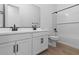 Bathroom with white cabinets and a bathtub at 37645 W Padilla St, Maricopa, AZ 85138