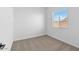 Well-lit bedroom featuring carpet and a window at 37645 W Padilla St, Maricopa, AZ 85138