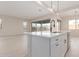 Kitchen island and breakfast bar with white cabinets at 20230 W Hollyhock St, Buckeye, AZ 85396