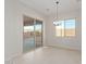 Light-filled dining area with sliding glass doors and chandelier at 20230 W Hollyhock St, Buckeye, AZ 85396