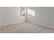 Well-lit bedroom featuring neutral walls and carpet flooring at 20230 W Hollyhock St, Buckeye, AZ 85396