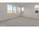 Bright bedroom with carpet flooring and large windows at 20230 W Hollyhock St, Buckeye, AZ 85396